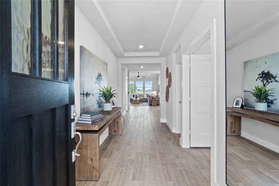 This dedicated area features a custom built-in bench with hooks, perfect for organizing coats, bags, and shoes right off the main hallway, keeping the rest of the home tidy. This dedicated area features a custom built-in bench with hooks, perfect for organizing coats, bags, and shoes right off the main hallway, keeping the rest of the home tidy.