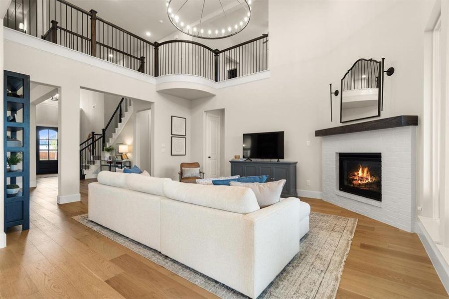 The open floorplan is light and bright, with soaring ceilings and decorative light fixtures throughout.