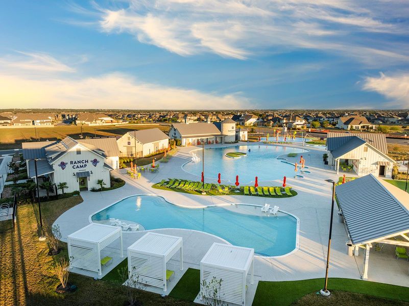 Community pool with a patio area and a residential view