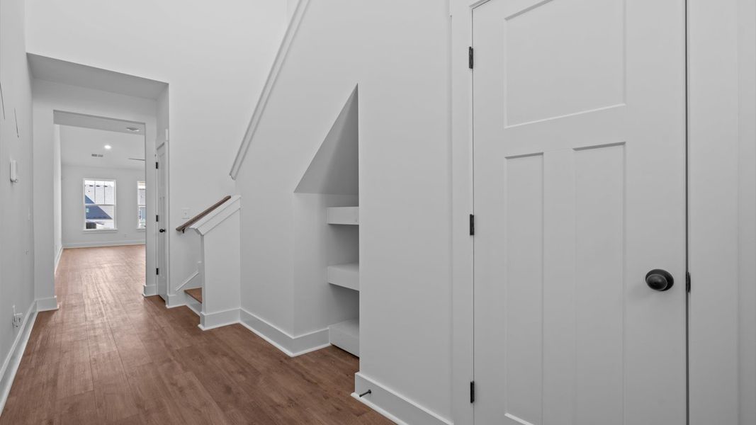 Stylish foyer with hardwood flooring and tasteful architectural detail in a superior layout