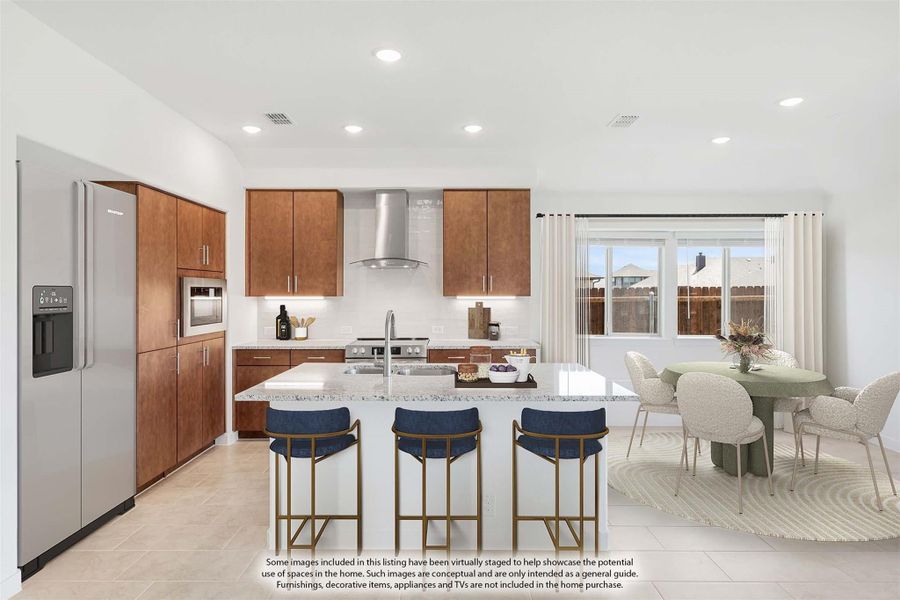 Kitchen with wood cabinets, center island with three bar stools, stainless steel appliances, and adjacent dining area