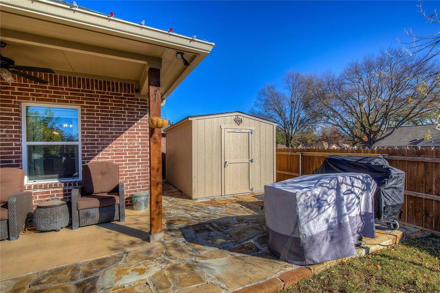 View of patio / terrace featuring a storage shed