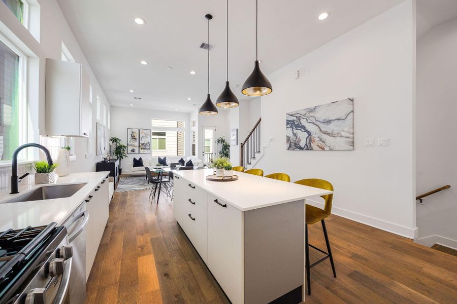 Sleek, modern kitchen with stainless steel appliances, elegant Italian cabinetry, soft closing cabinets/drawers, and a spacious island perfect for entertaining.