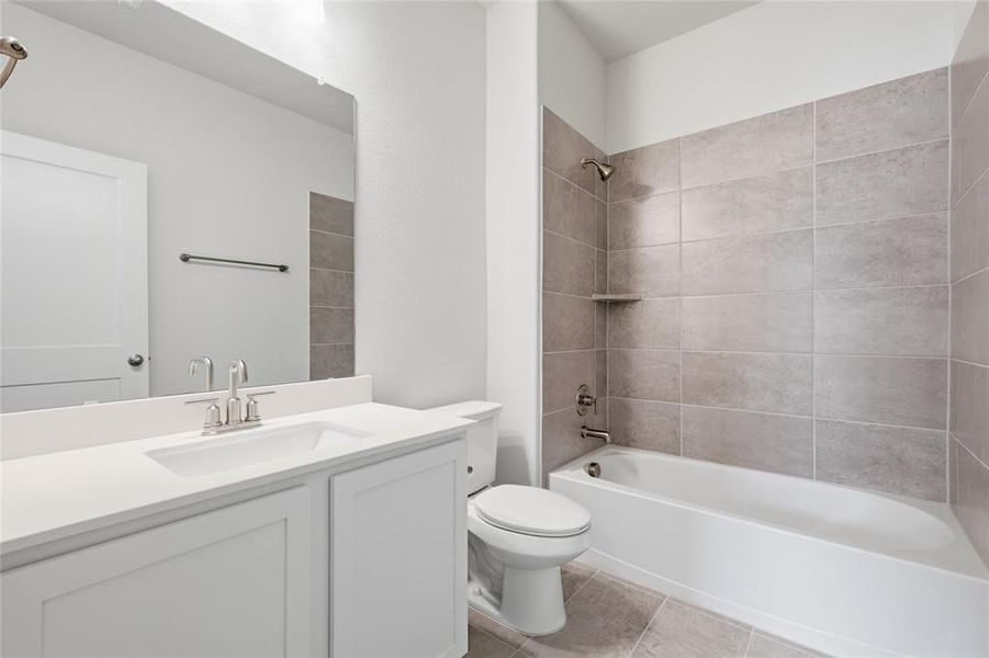 Bathroom featuring a white vanity with a rectangular sink and a large mirror