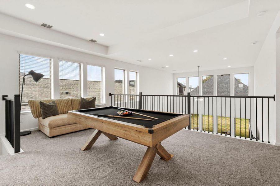 Game room showing the iron railing and panoramic views of the first floor. Game room showing the iron railing and panoramic views of the first floor.