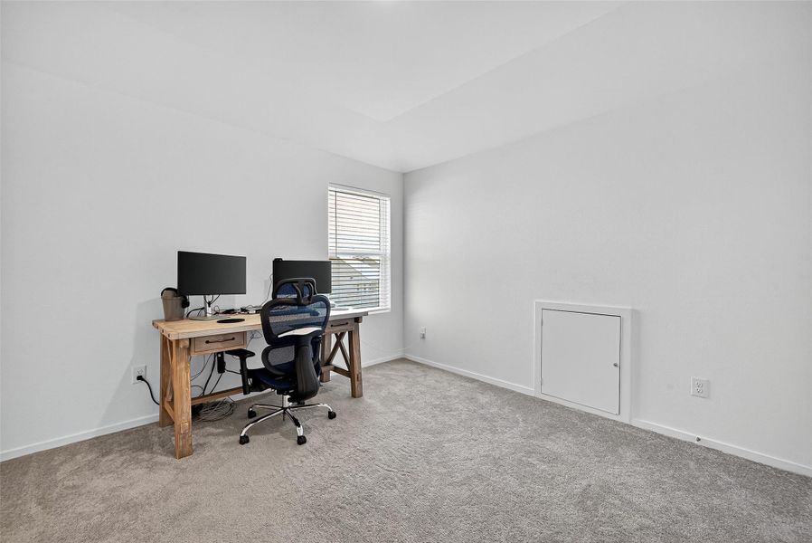 Bright upstairs bedroom with versatile space for work or relaxation. Bright upstairs bedroom with versatile space for work or relaxation.