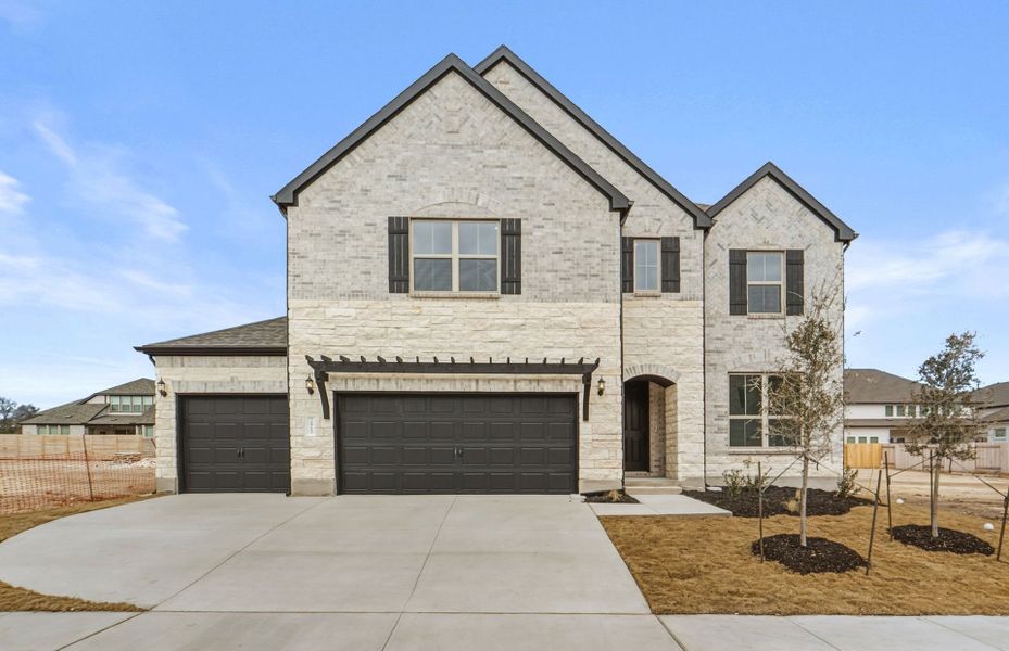 Front exterior of a new home in Bluffview Reserve, Leander, TX, highlighting curb appeal (Image 22). Front exterior of a new home in Bluffview Reserve, Leander, TX, highlighting curb appeal (Image 22).
