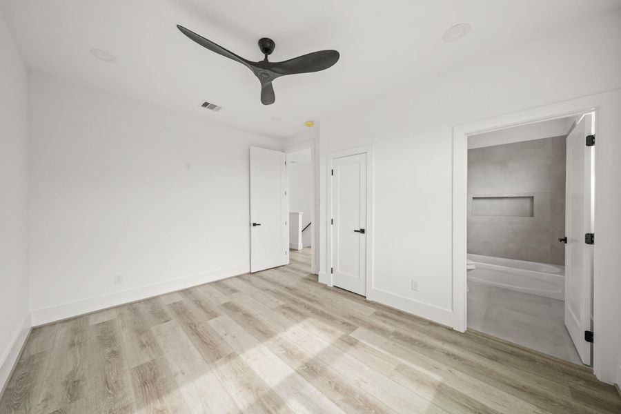 Functional finishes include recessed lights and a ceiling fan. A second closet sits to the right. Functional finishes include recessed lights and a ceiling fan. A second closet sits to the right.
