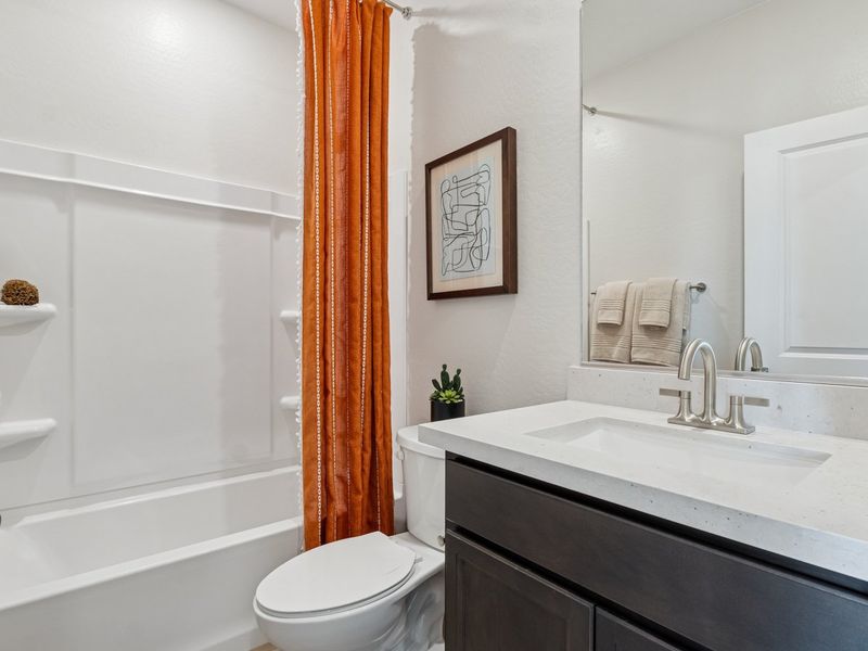 A bathroom with a tub sink and toilet. A bathroom with a tub sink and toilet.