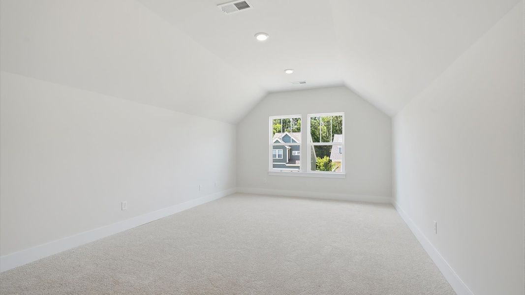 Stylish bonus room retreat with carpeted flooring and accomplished architectural detail at Iris Meadows Stylish bonus room retreat with carpeted flooring and accomplished architectural detail at Iris Meadows
