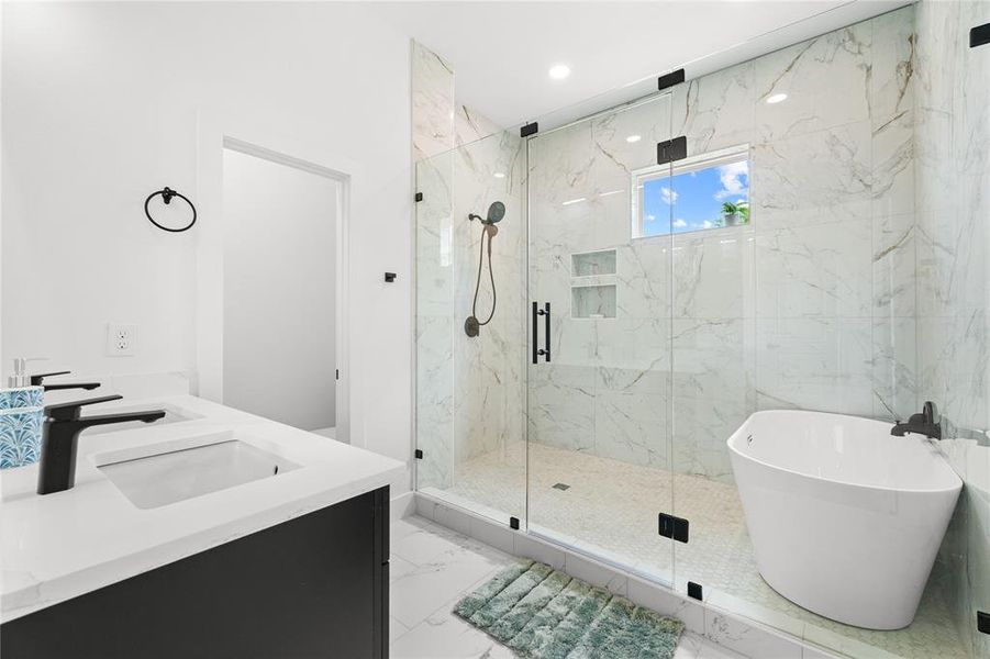 Contemporary bathroom featuring a dual vanity with undermount sinks and matte black fixtures