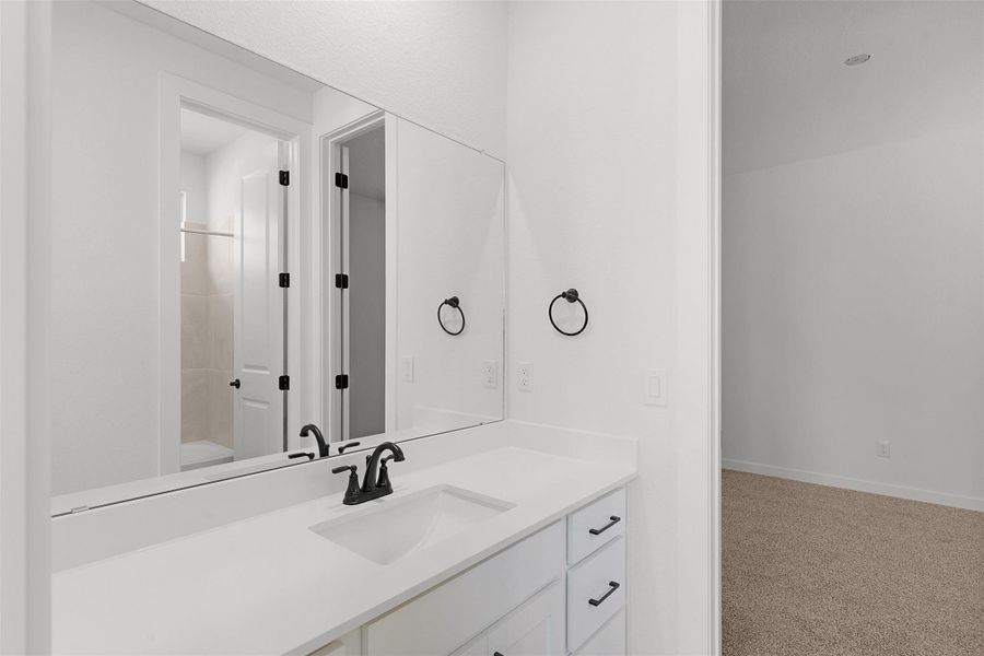 Bathroom featuring vanity, shower / bath combination, and light carpet