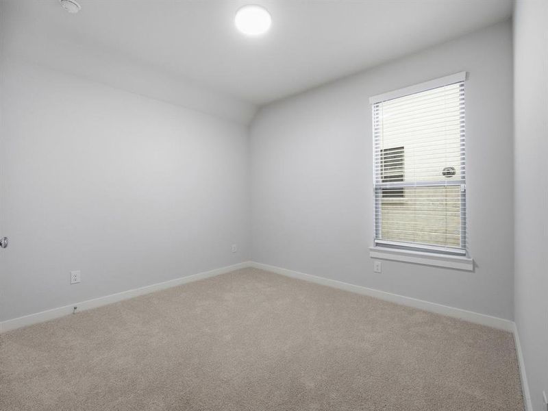 Carpeted empty room with baseboards
