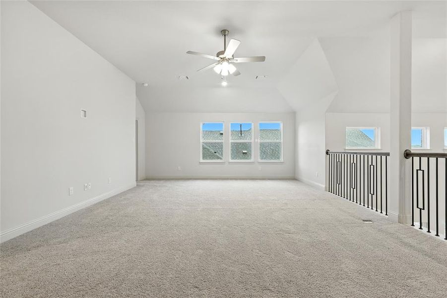 Bonus room featuring vaulted ceiling, carpet floors, and ceiling fan