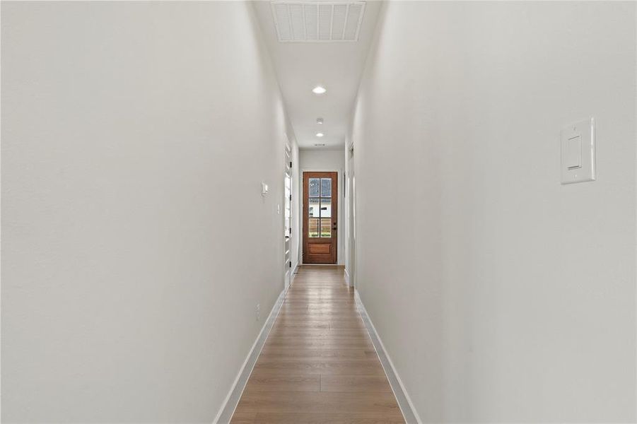 Hall featuring recessed lighting and light wood-style flooring Hall featuring recessed lighting and light wood-style flooring