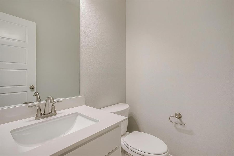 Half bath with toilet and vanity Half bath with toilet and vanity