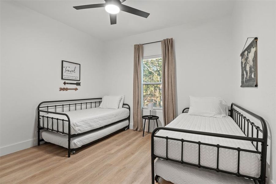 Bedroom featuring ceiling fan and light hardwood / wood-style flooring