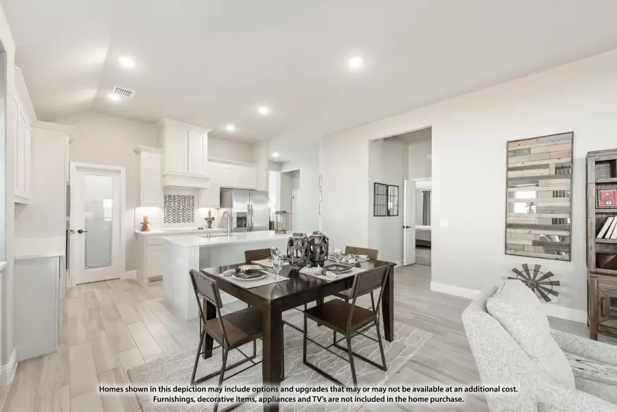Open-concept dining area with dark wood table, white kitchen, and light wood-look tile floors
