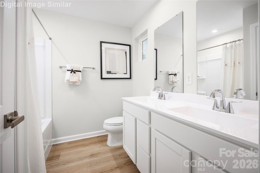 Relax and recharge in this spa-inspired owner’s bath—featuring dual ceramic sinks, generous space, and thoughtful storage for everyday luxury. Relax and recharge in this spa-inspired owner’s bath—featuring dual ceramic sinks, generous space, and thoughtful storage for everyday luxury.
