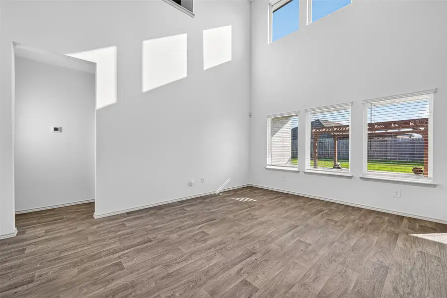 The spacious living room features amazing natural light from the wall of windows.