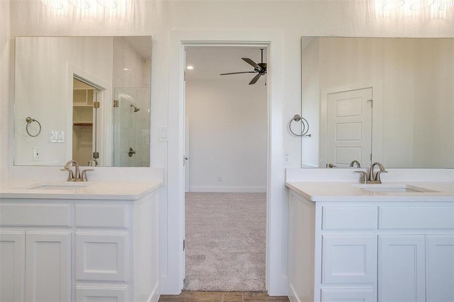 Bathroom featuring vanity, ceiling fan, and walk in shower