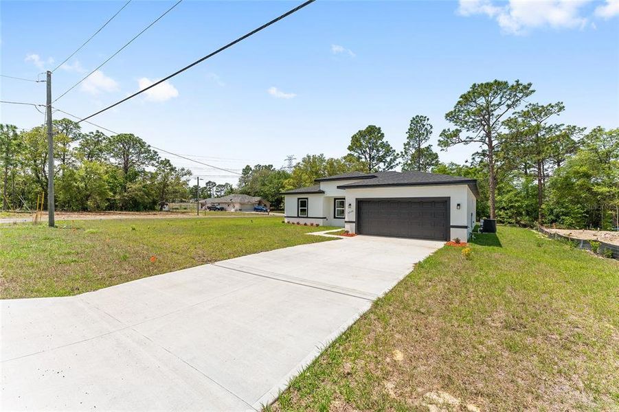 Front exterior of a new home in , Citrus Springs, FL, highlighting curb appeal (Image 16).