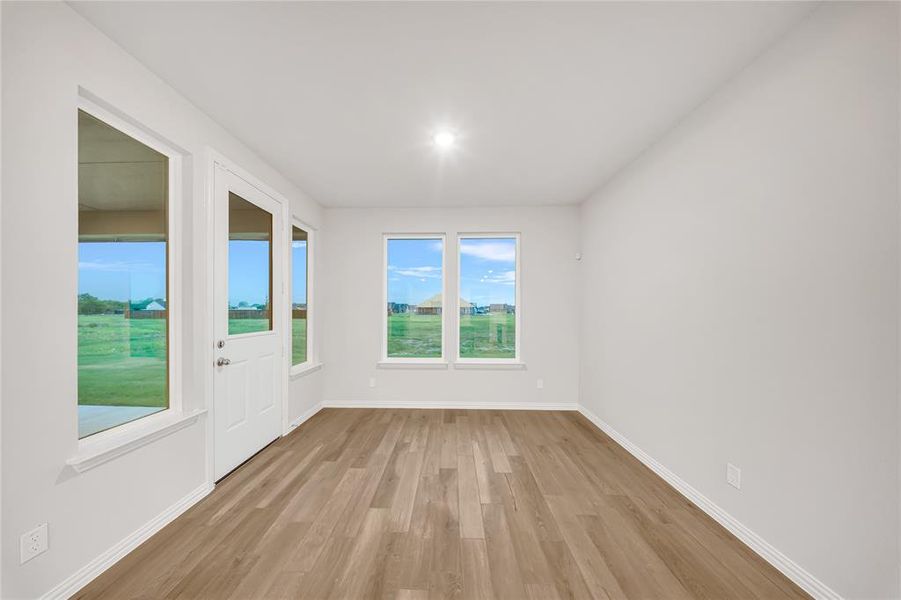 Unfurnished room featuring light wood finished floors and baseboards Unfurnished room featuring light wood finished floors and baseboards