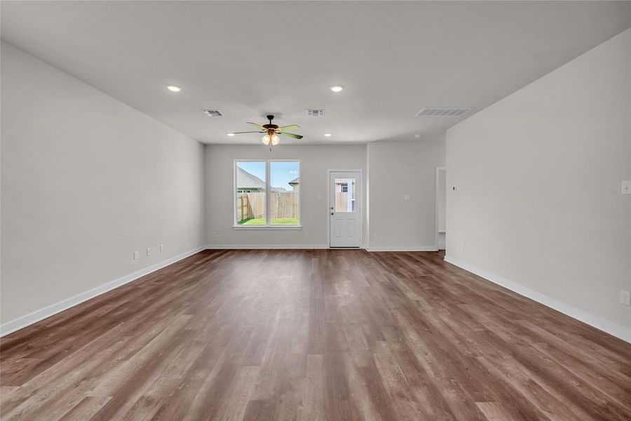 Unfurnished living room featuring recessed lighting, wood finished floors, and a ceiling fan Unfurnished living room featuring recessed lighting, wood finished floors, and a ceiling fan