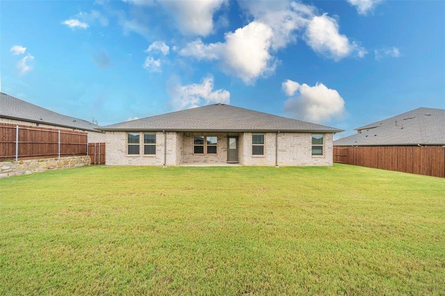 Backyard is large with wood privacy fence