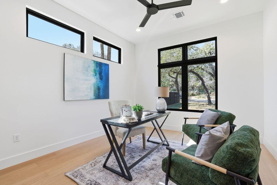 Home office featuring light wood finished floors, ceiling fan, and recessed lighting