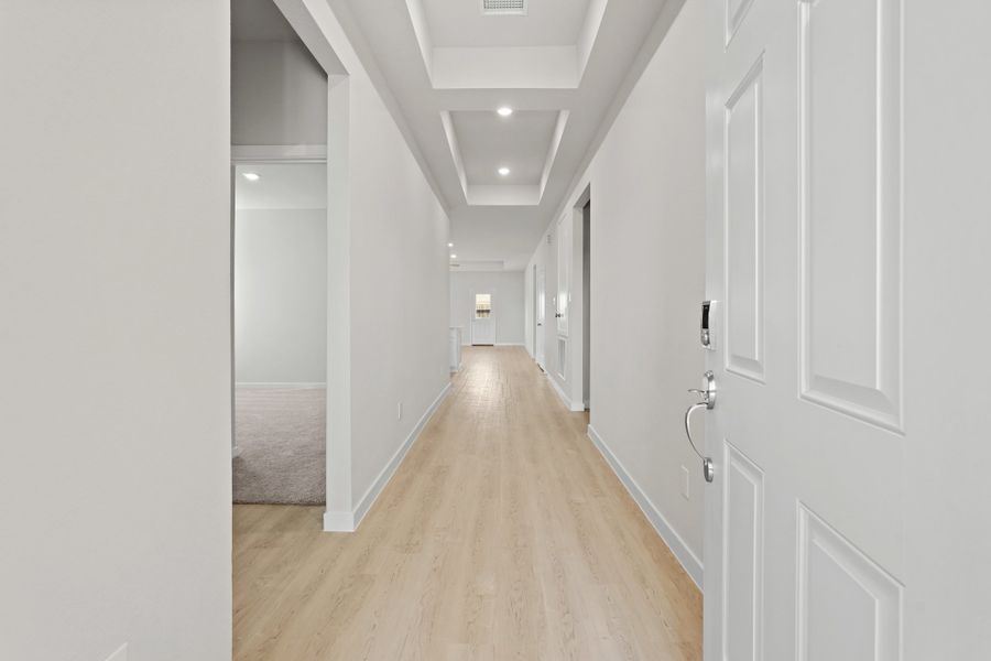 A hallway with white doors. A hallway with white doors.