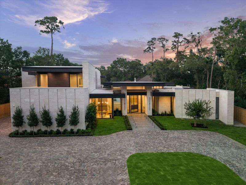 Striking modern masterpiece by Levant Luxury Homes, set on a premier 42,228 SF lot in the heart of Memorial. Clean architectural lines, soaring glass walls, and elegant exterior lighting showcase this gated estate’s exceptional design and commanding curb appeal.