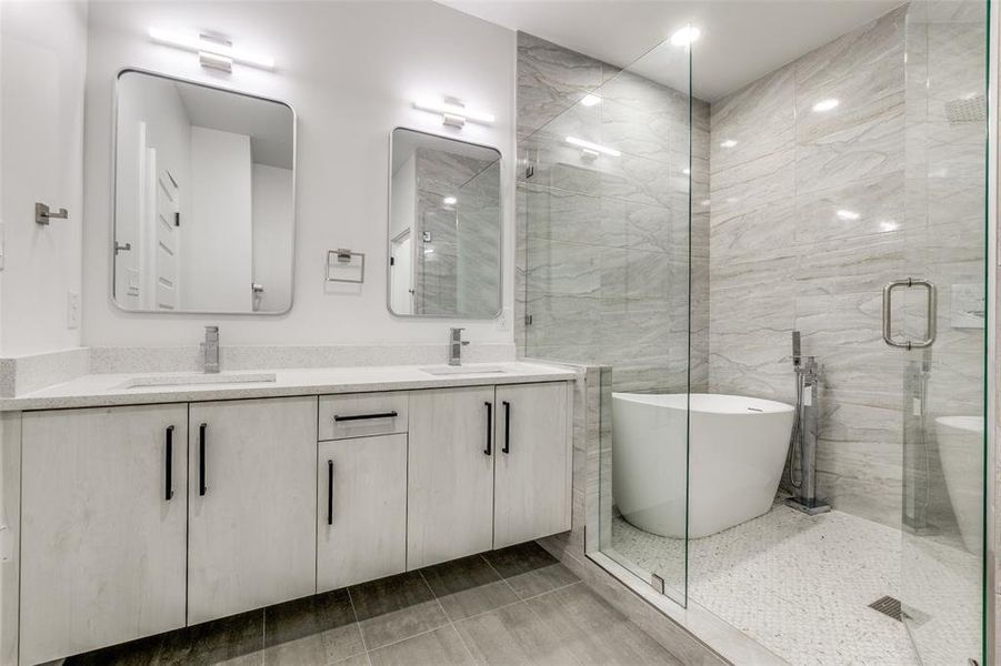 Master Spa Bathroom with a soaking tub, a shower double vanity, and a sink ensuite to Master bedroom and closet