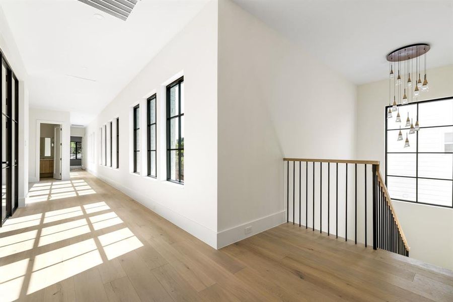 Hall with wood finished floors and baseboards Hall with wood finished floors and baseboards