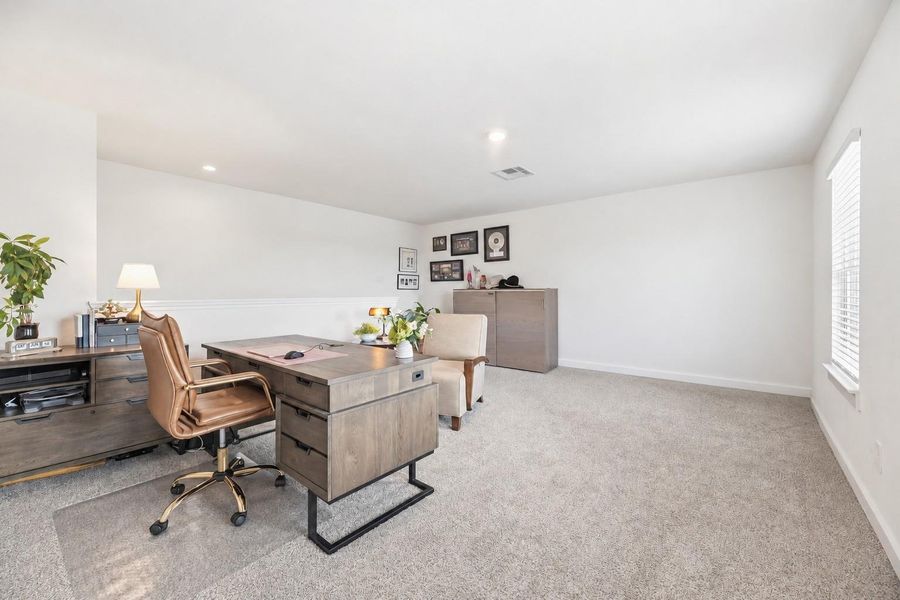 Second-floor game room with carpet and natural light, flexible for a media room, playroom or home office.