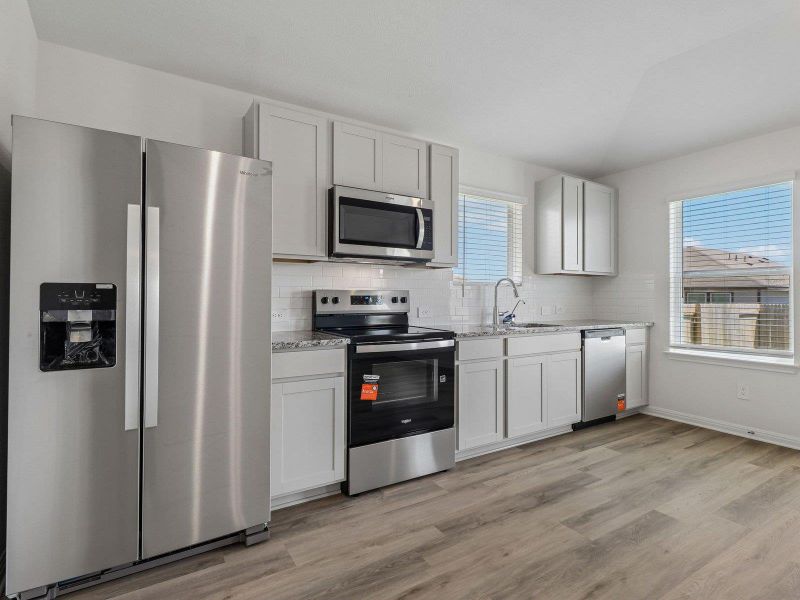 Modern cabinetry and solid flooring anchor this well-appointed kitchen space.