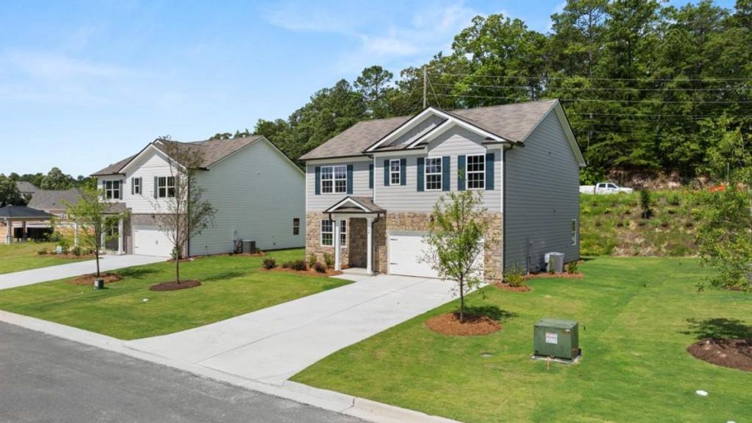 Front exterior of a new home in Northwoods at Mirror Lake, Villa Rica, GA, highlighting curb appeal (Image 17).