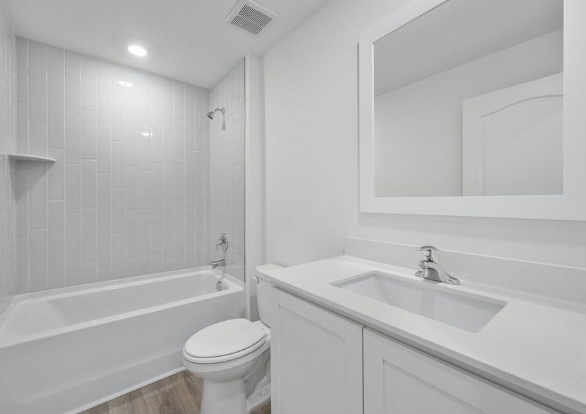A spacious secondary bathroom with tile detail
