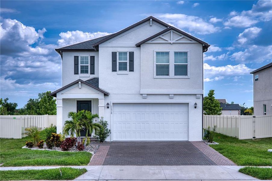 Front exterior of a new home in Stonegate Preserve, Palmetto, FL, highlighting curb appeal (Image 1). Front exterior of a new home in Stonegate Preserve, Palmetto, FL, highlighting curb appeal (Image 1).