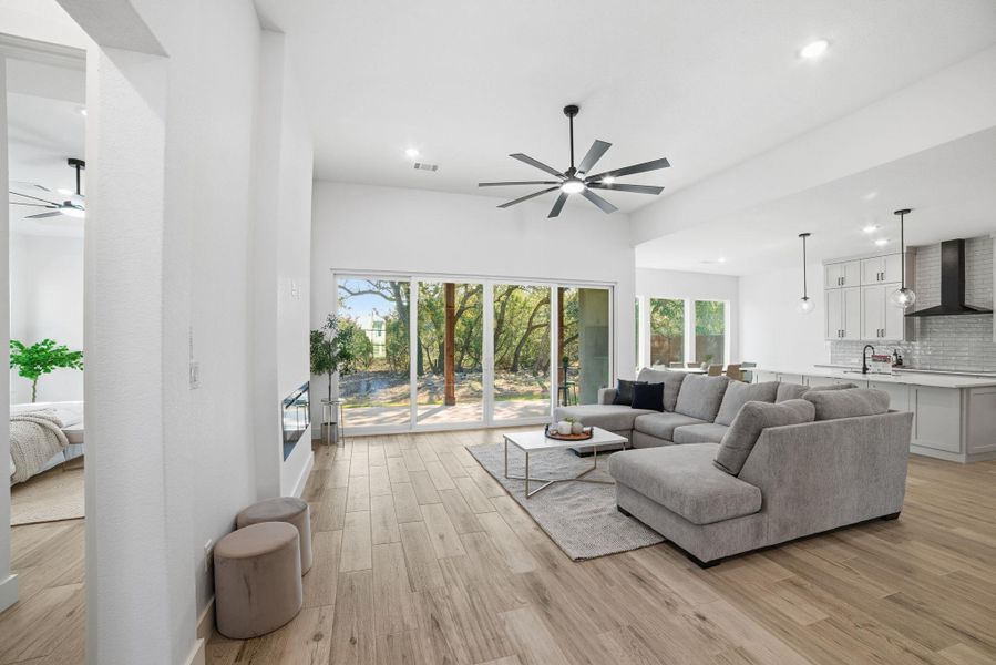 Living area with ceiling fan, light wood-style floors, and recessed lighting Living area with ceiling fan, light wood-style floors, and recessed lighting