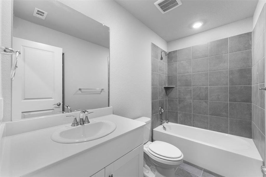 Bathroom featuring vanity, bathtub / shower combination, and tile patterned flooring Bathroom featuring vanity, bathtub / shower combination, and tile patterned flooring