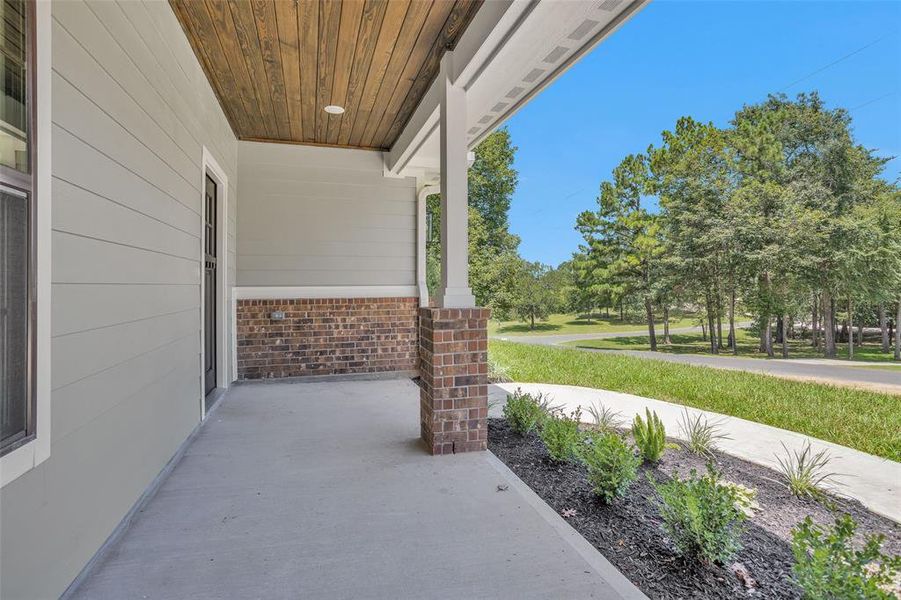 View of front porch looking out toward the street. Notice the beautiful wood planked ceiling