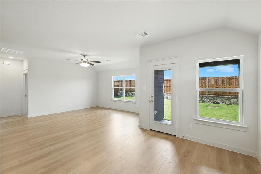 Entryway featuring wood finished floors, lofted ceiling, and ceiling fan Entryway featuring wood finished floors, lofted ceiling, and ceiling fan