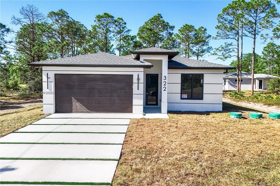 Front exterior of a new home in , Lehigh Acres, FL, highlighting curb appeal (Image 1). Front exterior of a new home in , Lehigh Acres, FL, highlighting curb appeal (Image 1).