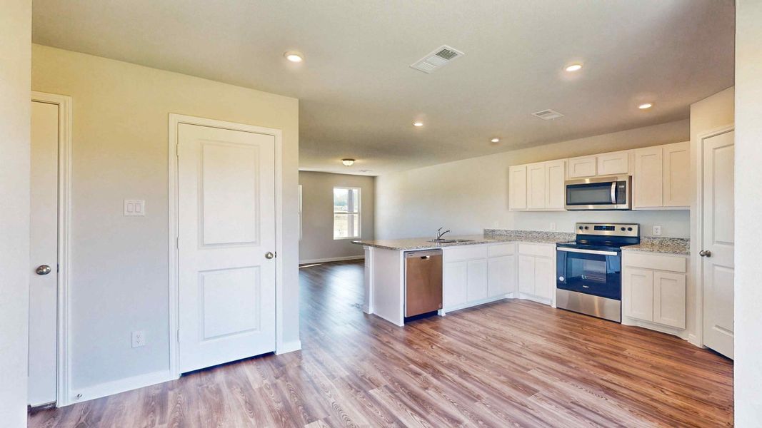 A kitchen with white cabinets.