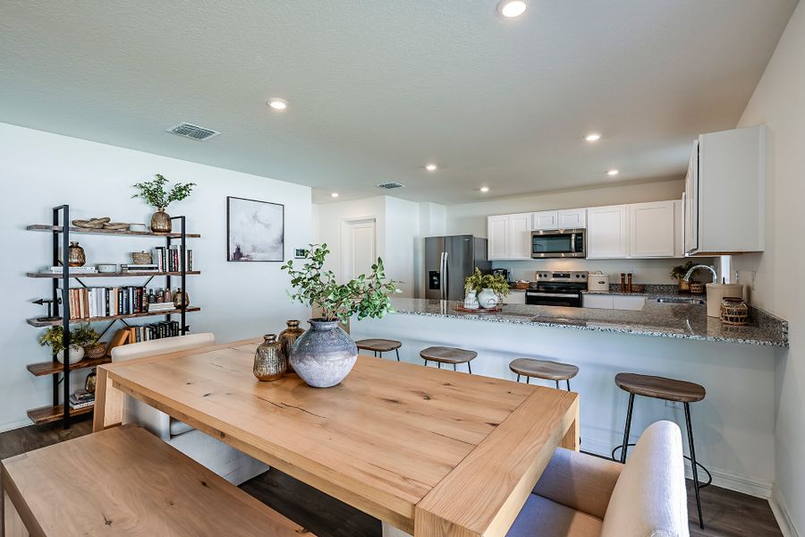 A kitchen with a table and chairs. A kitchen with a table and chairs.