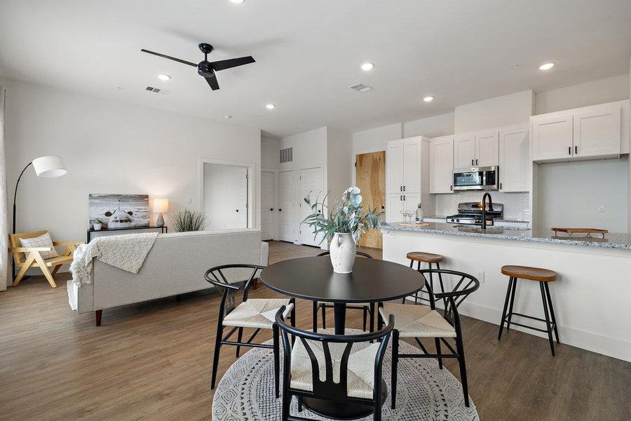 Dining room featuring dark wood-type flooring, recessed lighting, and a ceiling fan