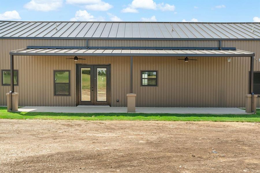 Back of house featuring french doors and covered porch