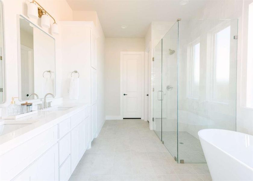 Bathroom with tile patterned flooring, vanity, plenty of natural light, and shower with separate bathtub