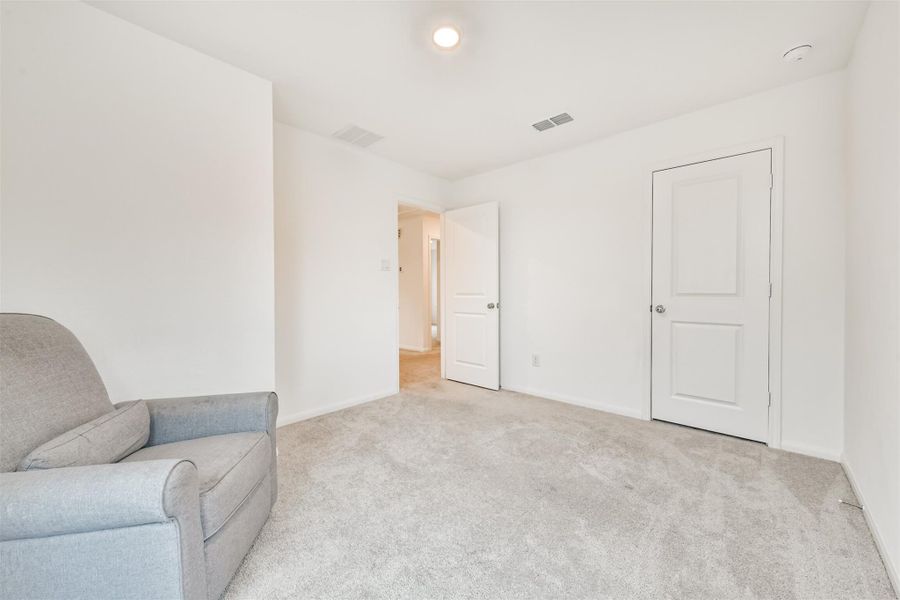 Another view of the bedroom #4 is bright and spacious with neutral walls and carpet. Located on the second floor.